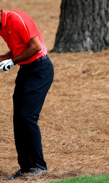 Tiger hits root, hurts wrist, says bone 'popped out' but 'I put it back in'